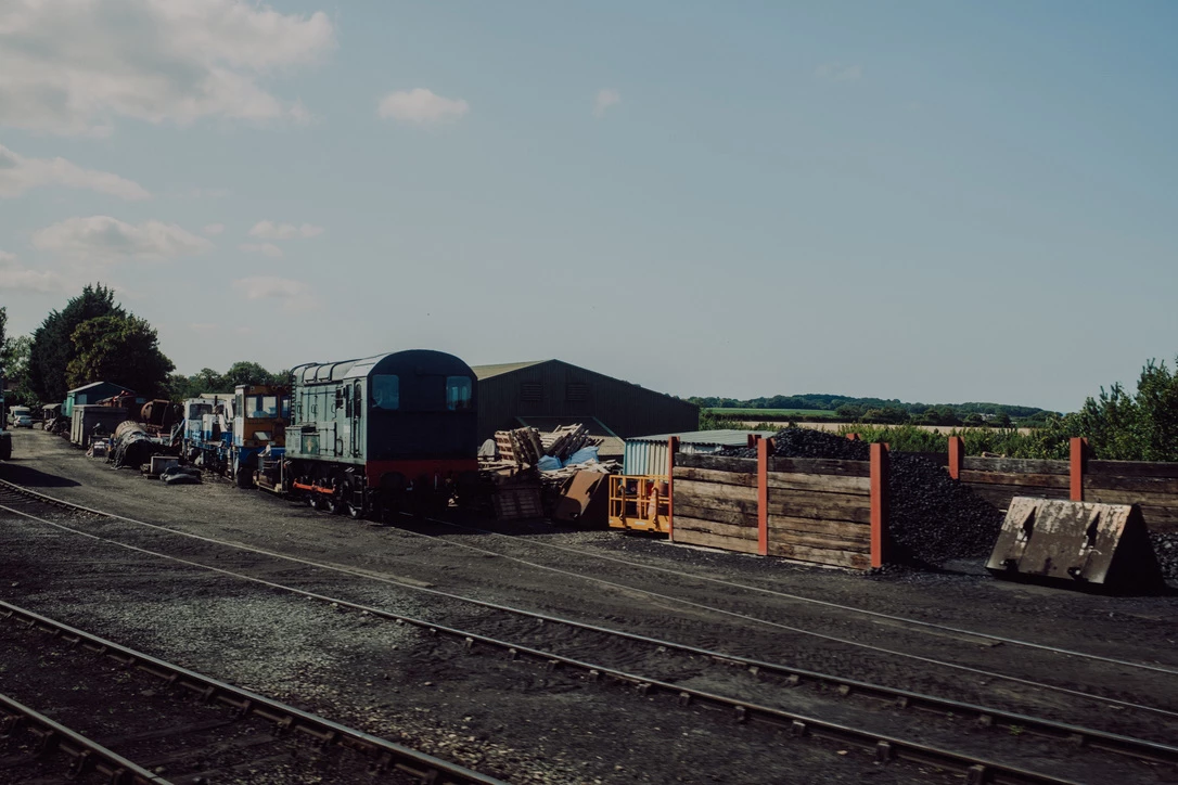 Train yard with a class 08 locomotive in a dark green livery. Photograph by Dave Smyth.